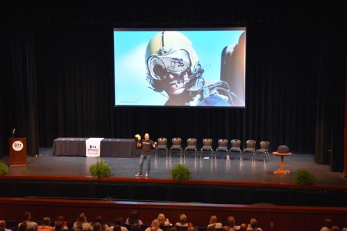 John Foley holding up helmet he flew with the Blue Angels